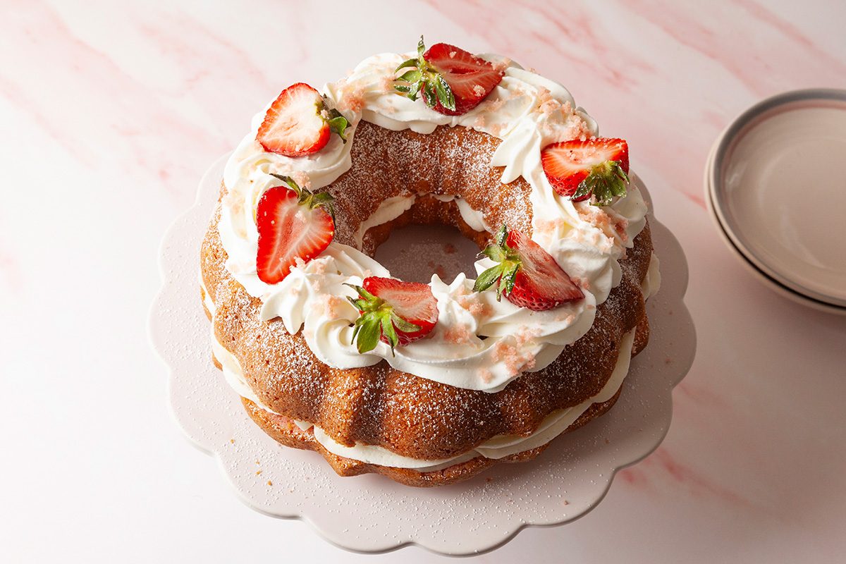 Spread strawberry jam over the cut side of the other half of the cake