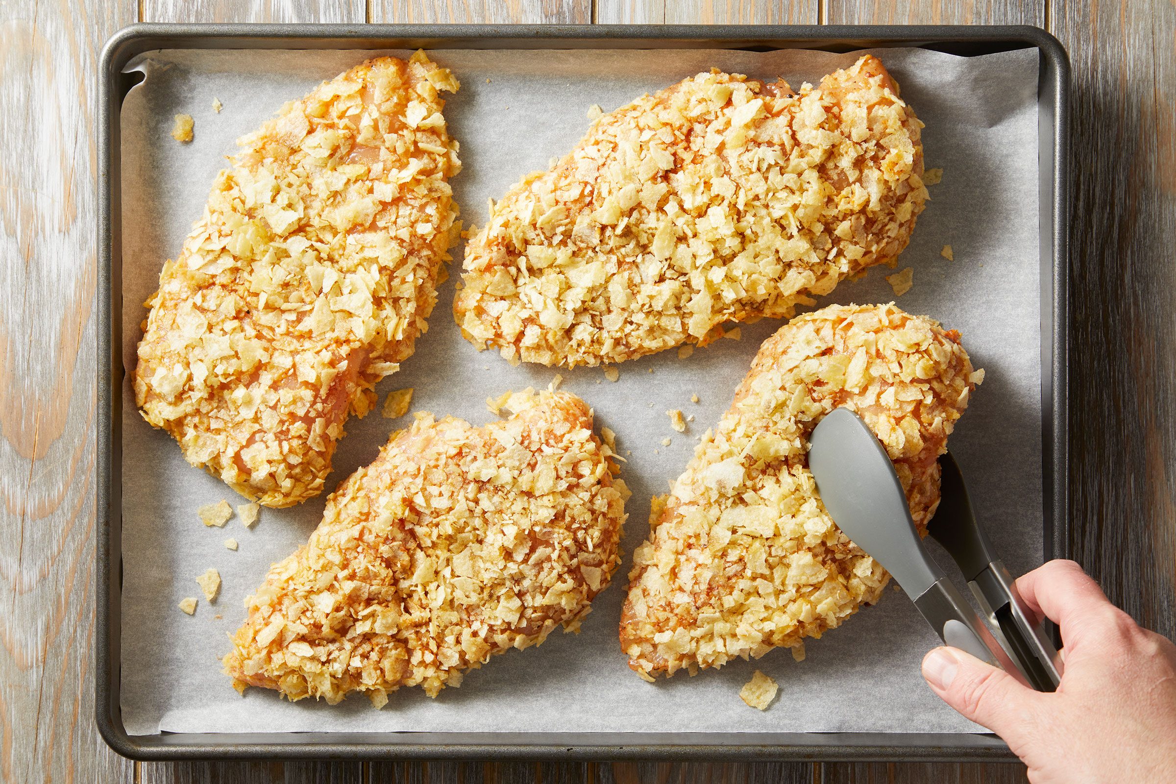 Baking the coated chicken on foil-lined baking sheets