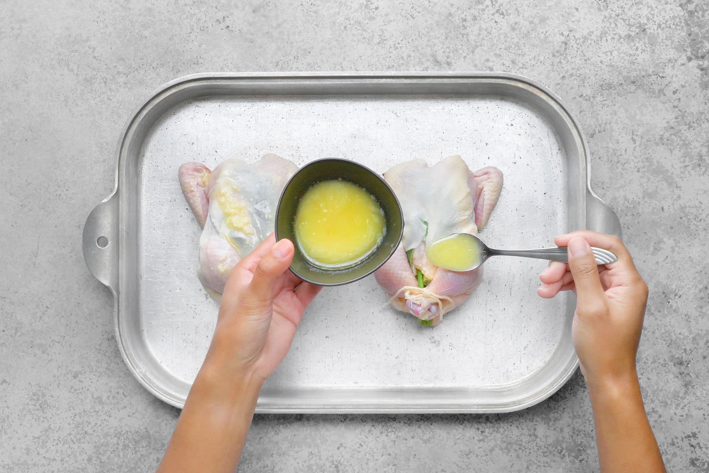 Melted butter, olive oil, lemon juice and garlic spooned all over the hens