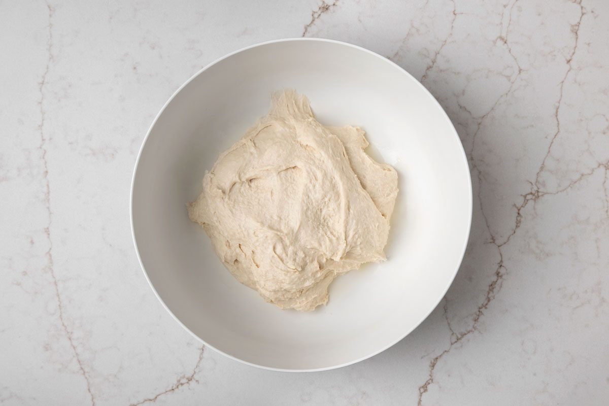 In a large bowl combine 2-3/4 cups flour; sugar; salt and yeast; Add the water and oil; beat just until smooth