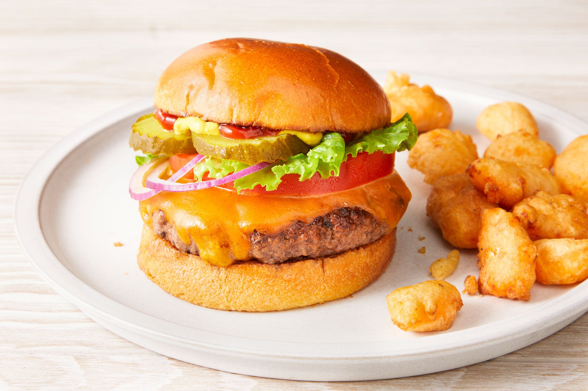 Beauty shot of Easy Wisconsin Butter Burger served with Fried Cheese Curds