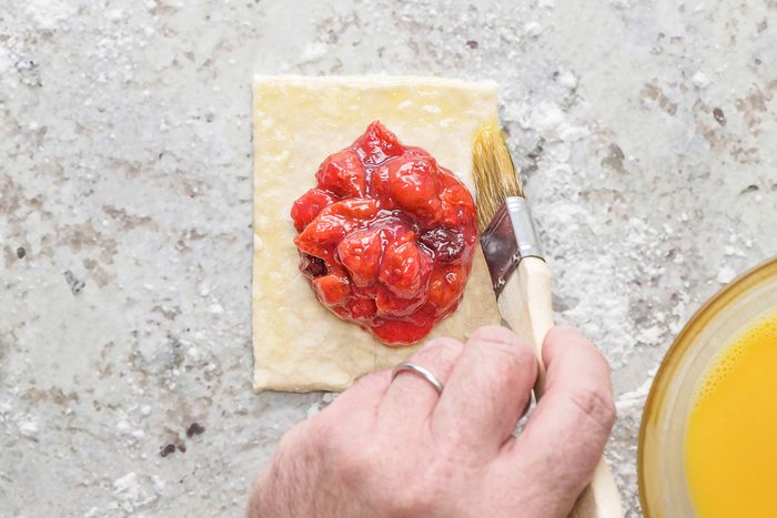 brushing dough with egg wash