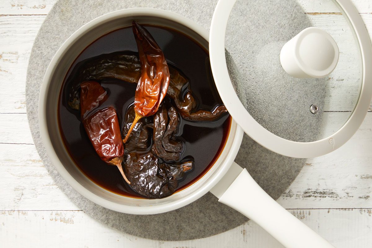 In a small saucepan, bring 1 cup stock to a boil. Add chilies.