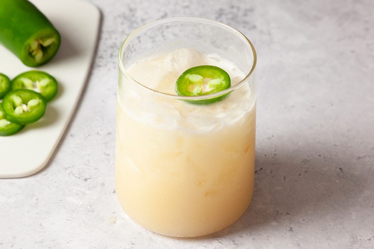 shot of Cowboy Colada garnished with a jalapeno round.