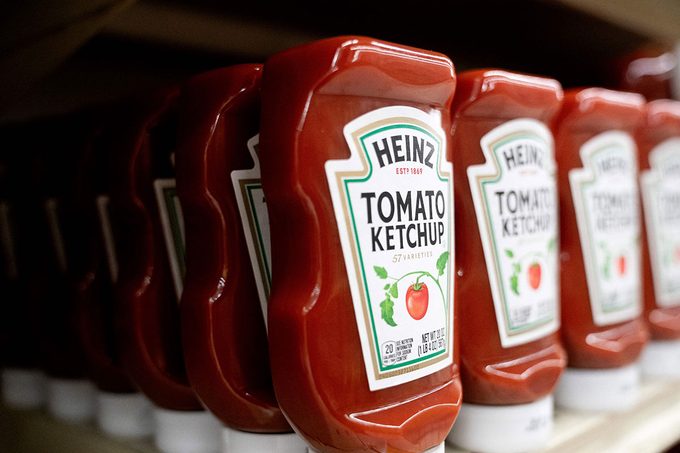 Heinz ketchup is displayed on a shelf at a grocery store