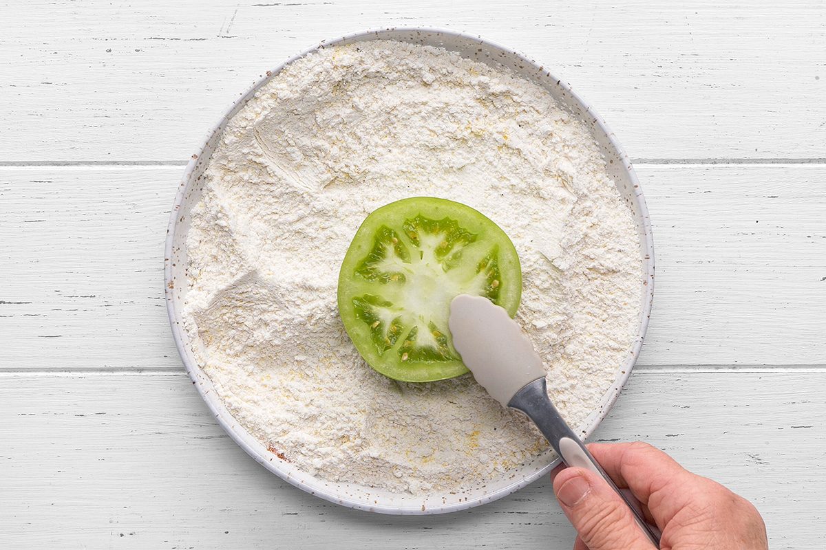 Dip both sides of each tomato slice into the mixture.