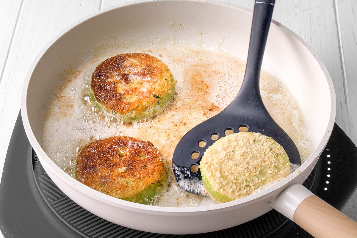 Fry tomatoes until brown on both sides but firm enough to hold their shape
