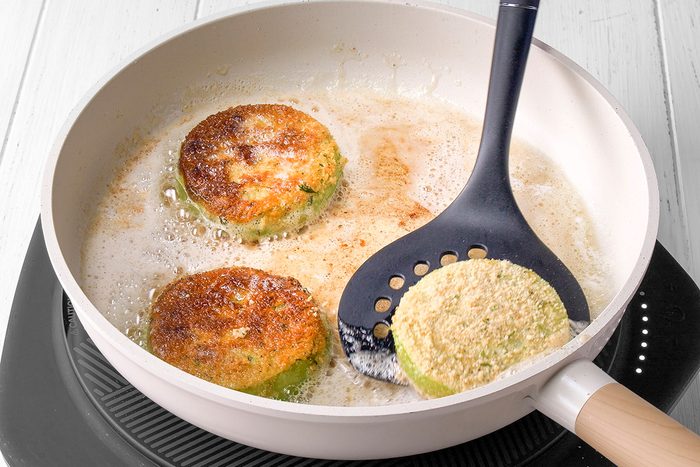 Fry tomatoes until brown on both sides but firm enough to hold their shape