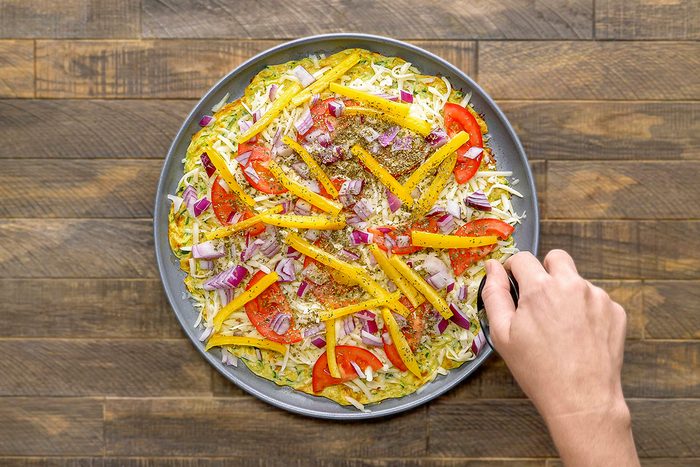 Top the pizza with herbs and remaining Parmesan cheese