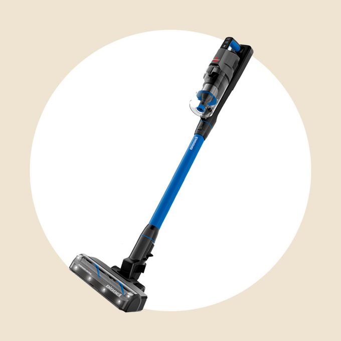 Bissel stick vacuum on a white and tan background