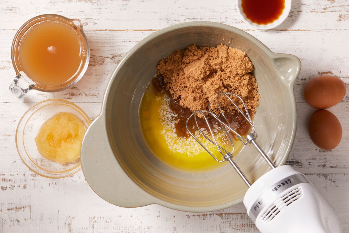 Beat in melted butter, eggs, apple cider, applesauce and vanilla until well blended.