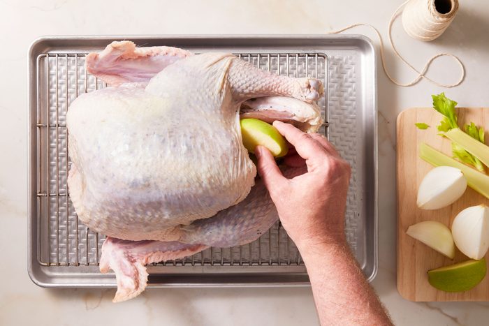 Place apple, onion and celery in turkey cavity;