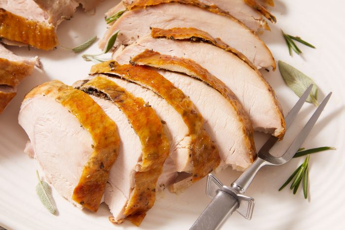 Close up shot of Apple & Herb Roasted Turkey; sliced