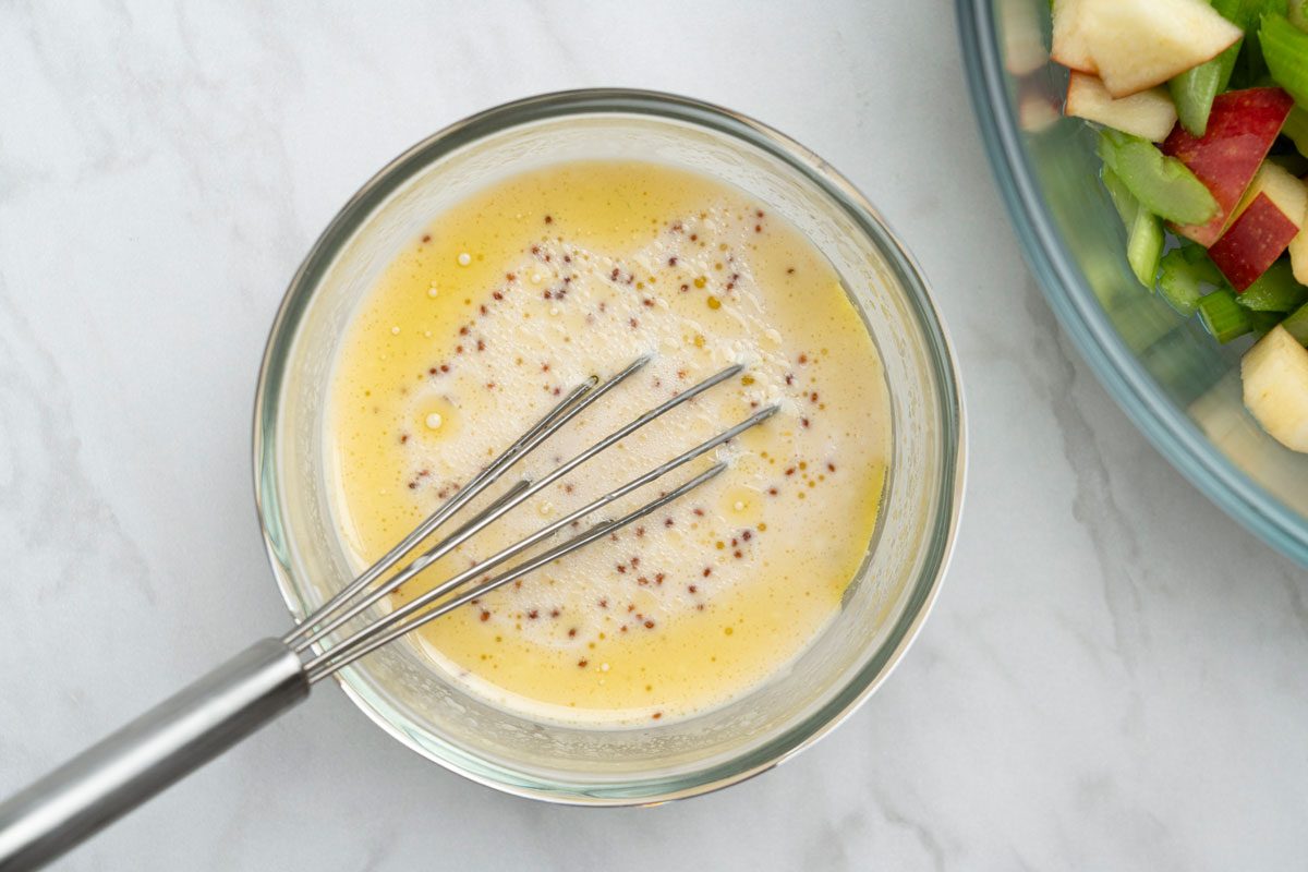 Overhead shot of whisking ingredients together on a marble surface;