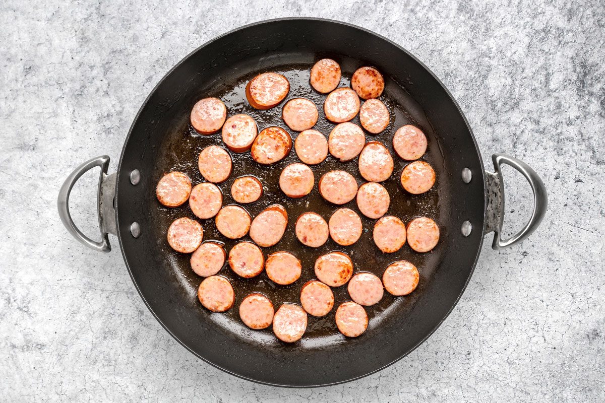 In a large skillet brown the sausage in 1 teaspoon oil