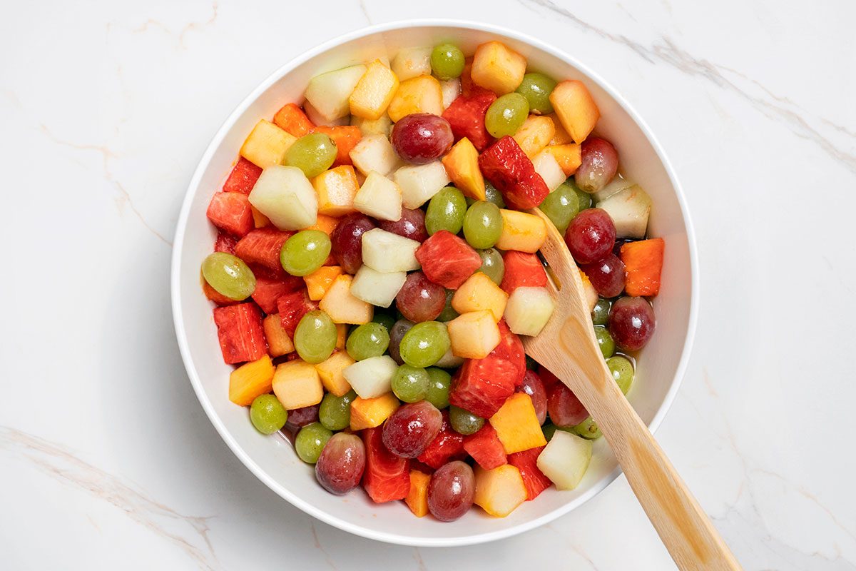 Sugar with the lemon, lime and orange juices poured over mixed fruits