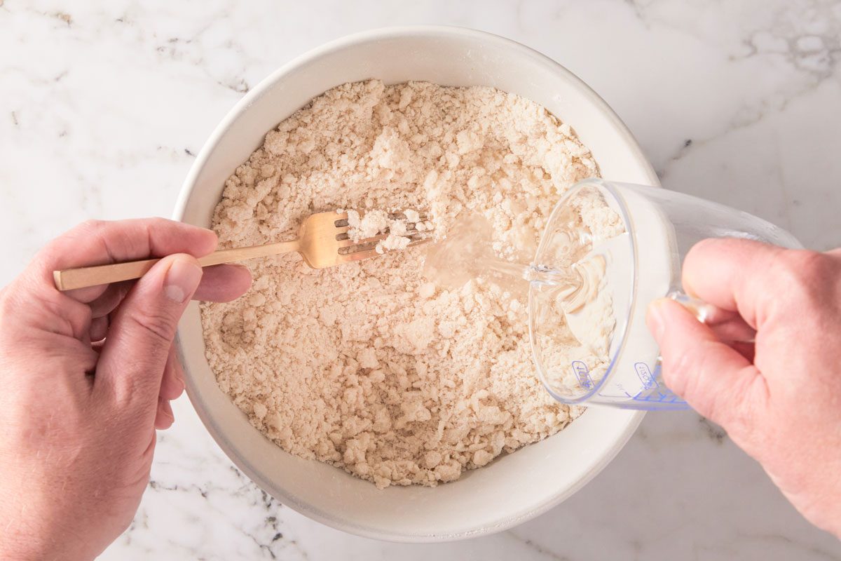 Gradually add ice water, tossing with a fork until dough holds together when pressed.