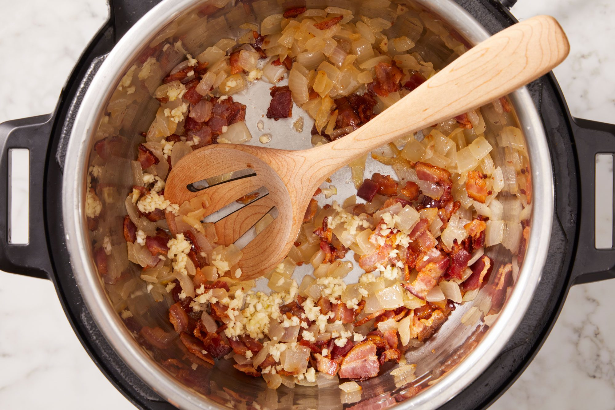 cook and stir bacon and onion until bacon is crisp and onions are tender