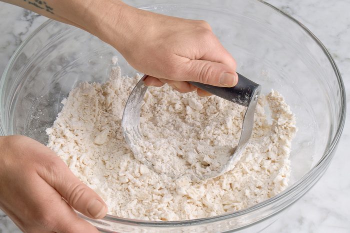 adding shortening to flour mixture