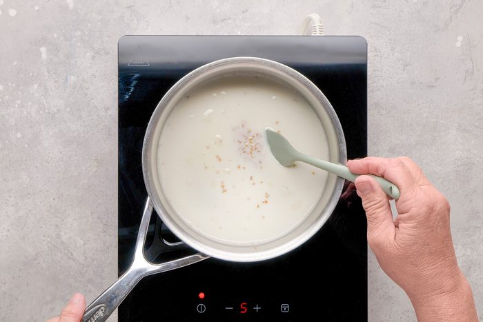 oats and milk being cooked in a pan