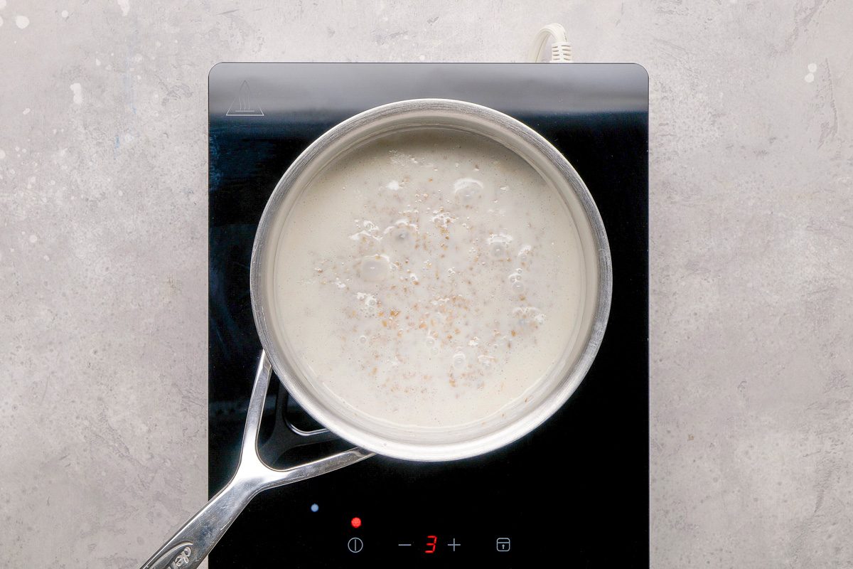 oats and milk being cooked in a pan