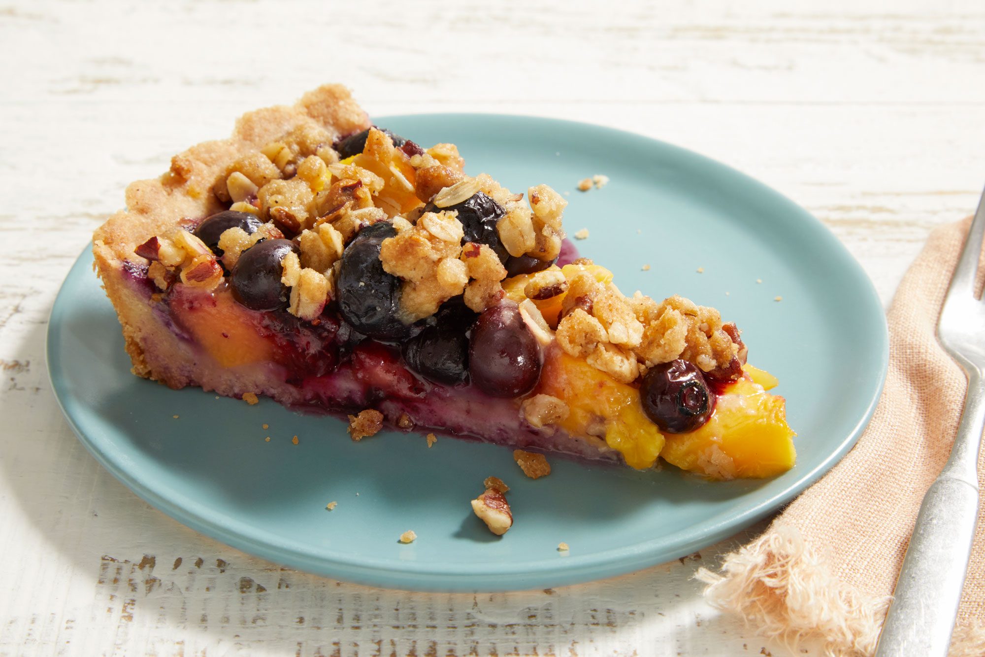 3/4 shot of Peach-Blueberry Crumble Tart slice