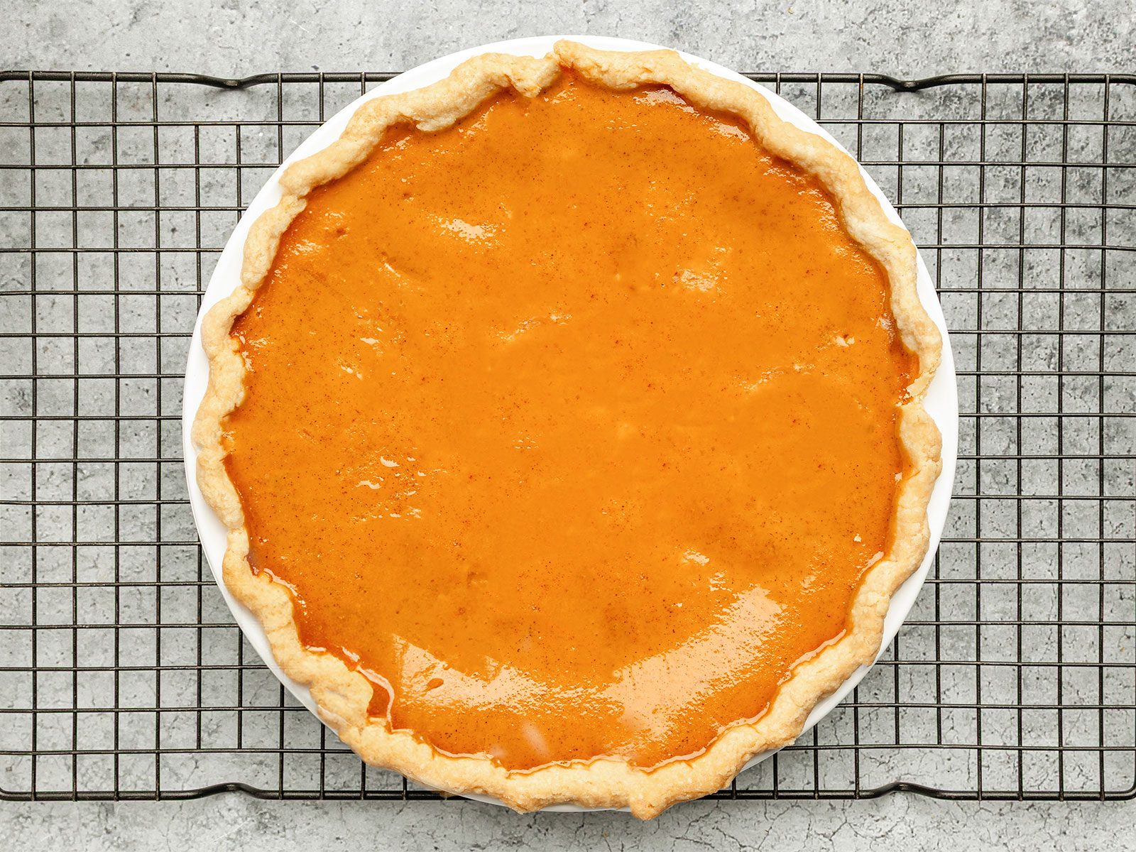 pumpkin apple pie on a cooling rack 
