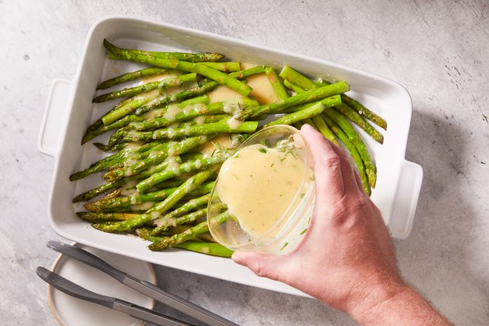 pour dressing over asparagus and turn to coat.