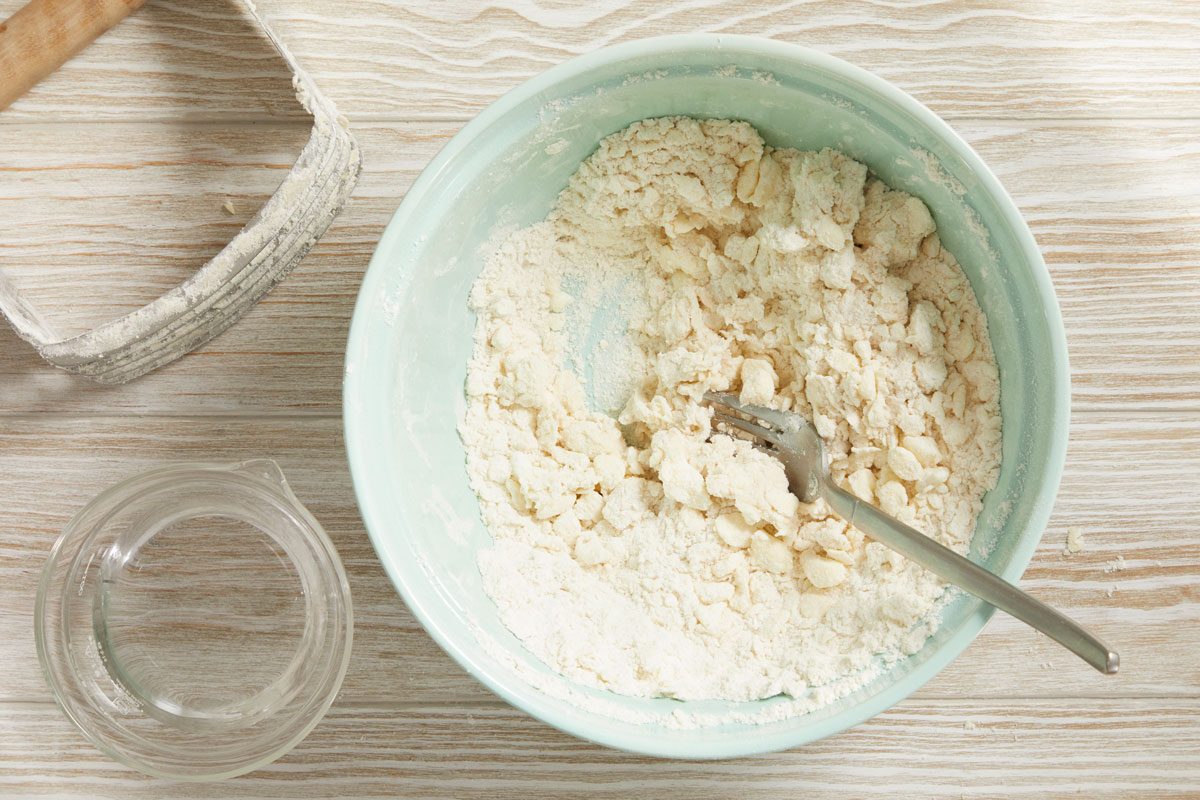 Gradually add ice water, tossing with a fork until dough forms a ball.