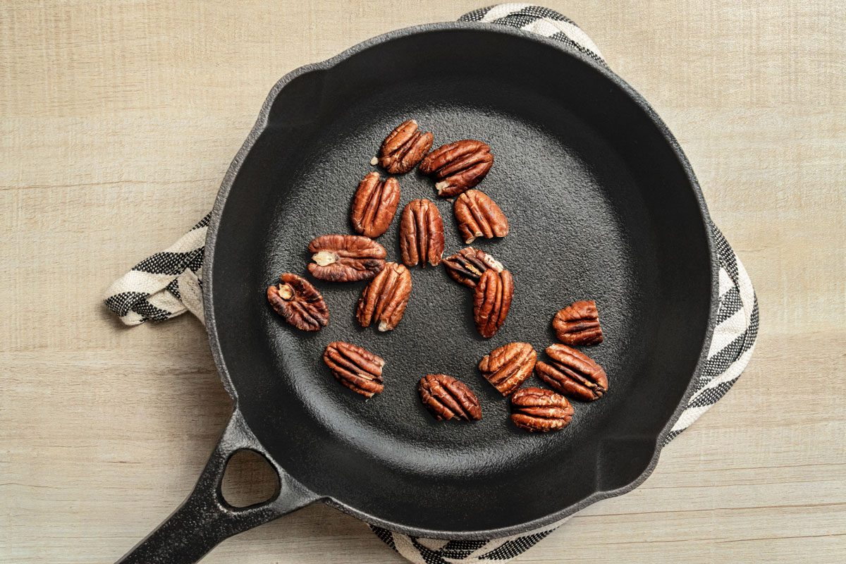 Place pecans in a small heavy skillet. Cook over medium heat