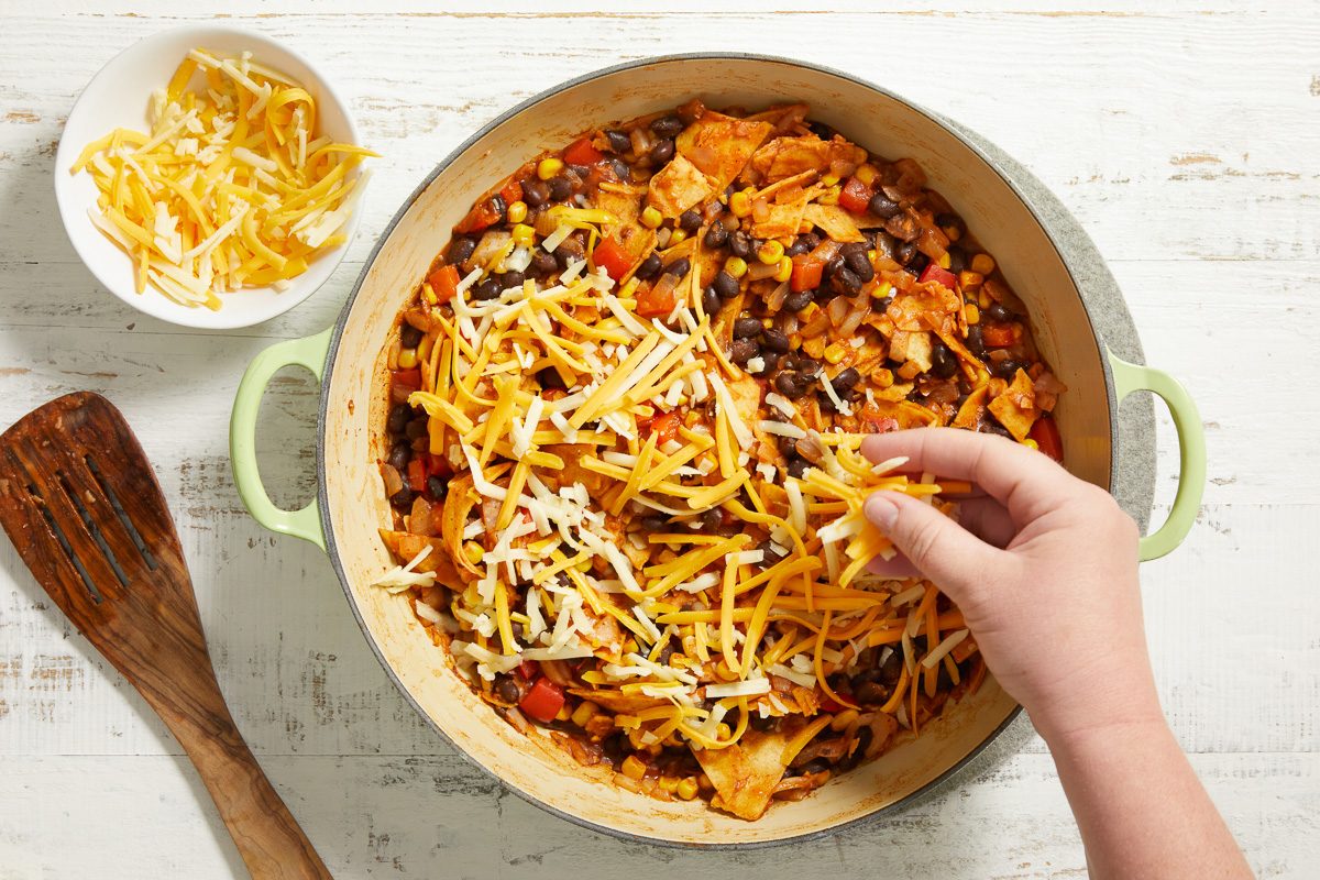 sprinkling cheese over skillet