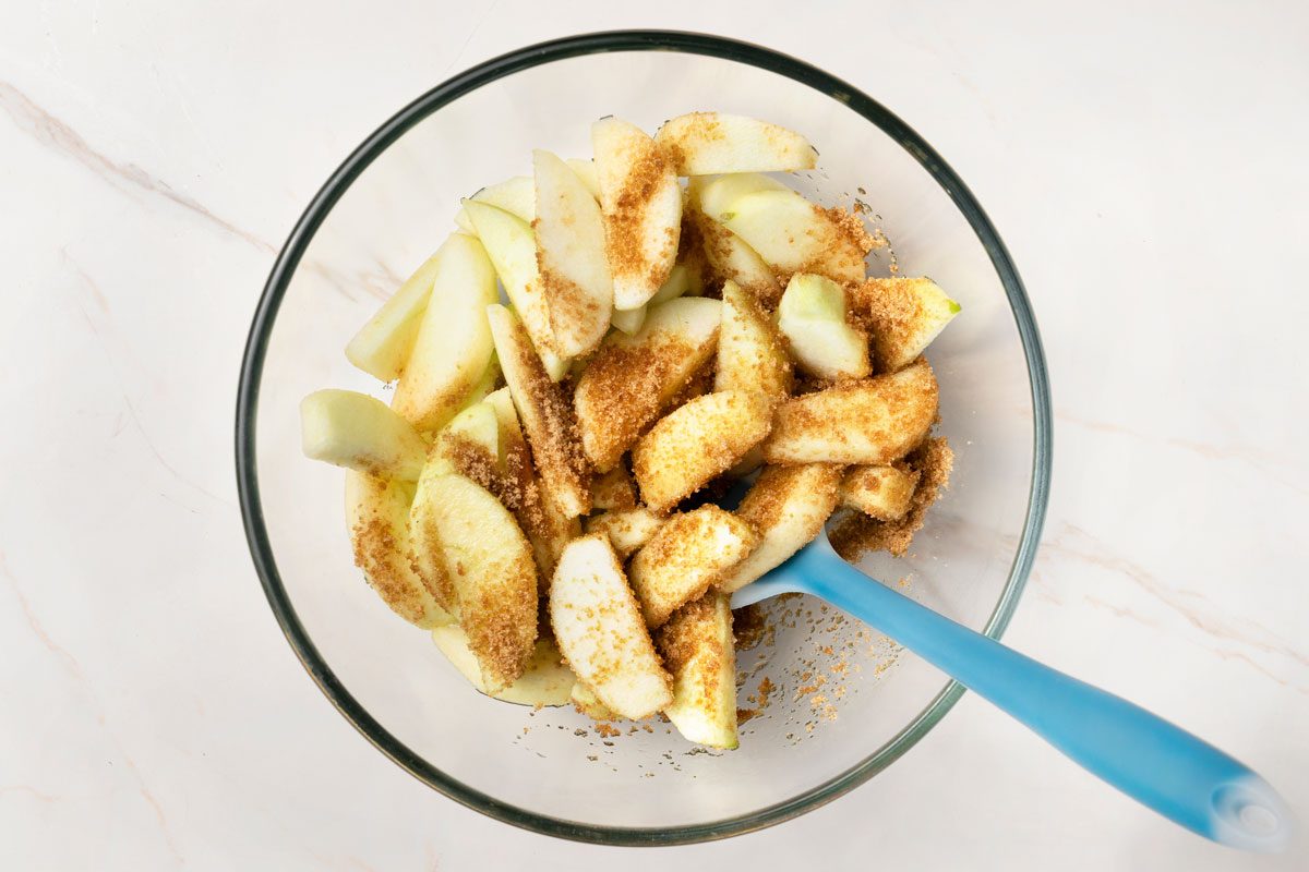 In a bowl, stir together apples and 1/4 cup brown sugar.