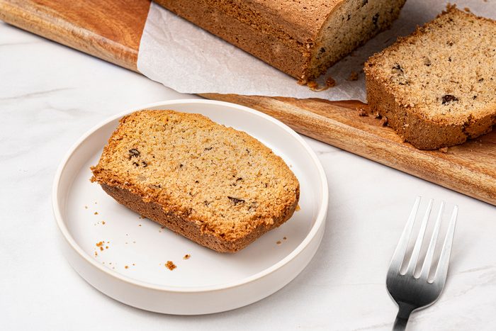 Cucumber Bread served on a white plate with a fork kept on side.