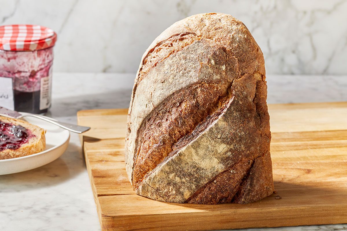 Half cutted bread placed on a wooden tray