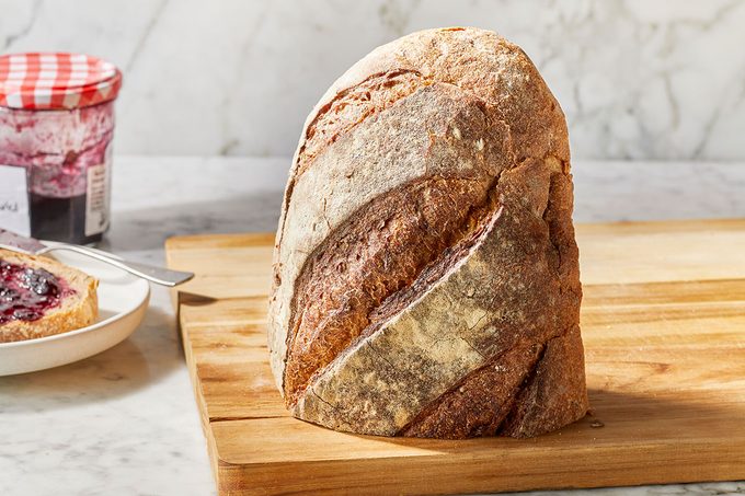 Half cutted bread placed on a wooden tray