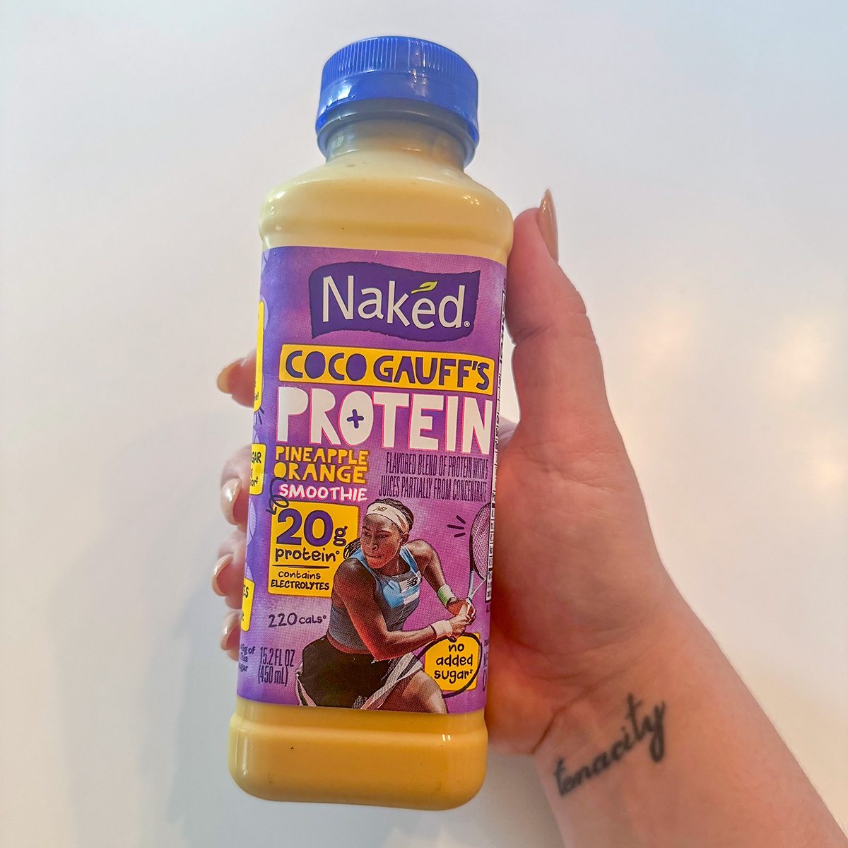 Coco Gauffs Naked Smoothie Bottle in a Hand