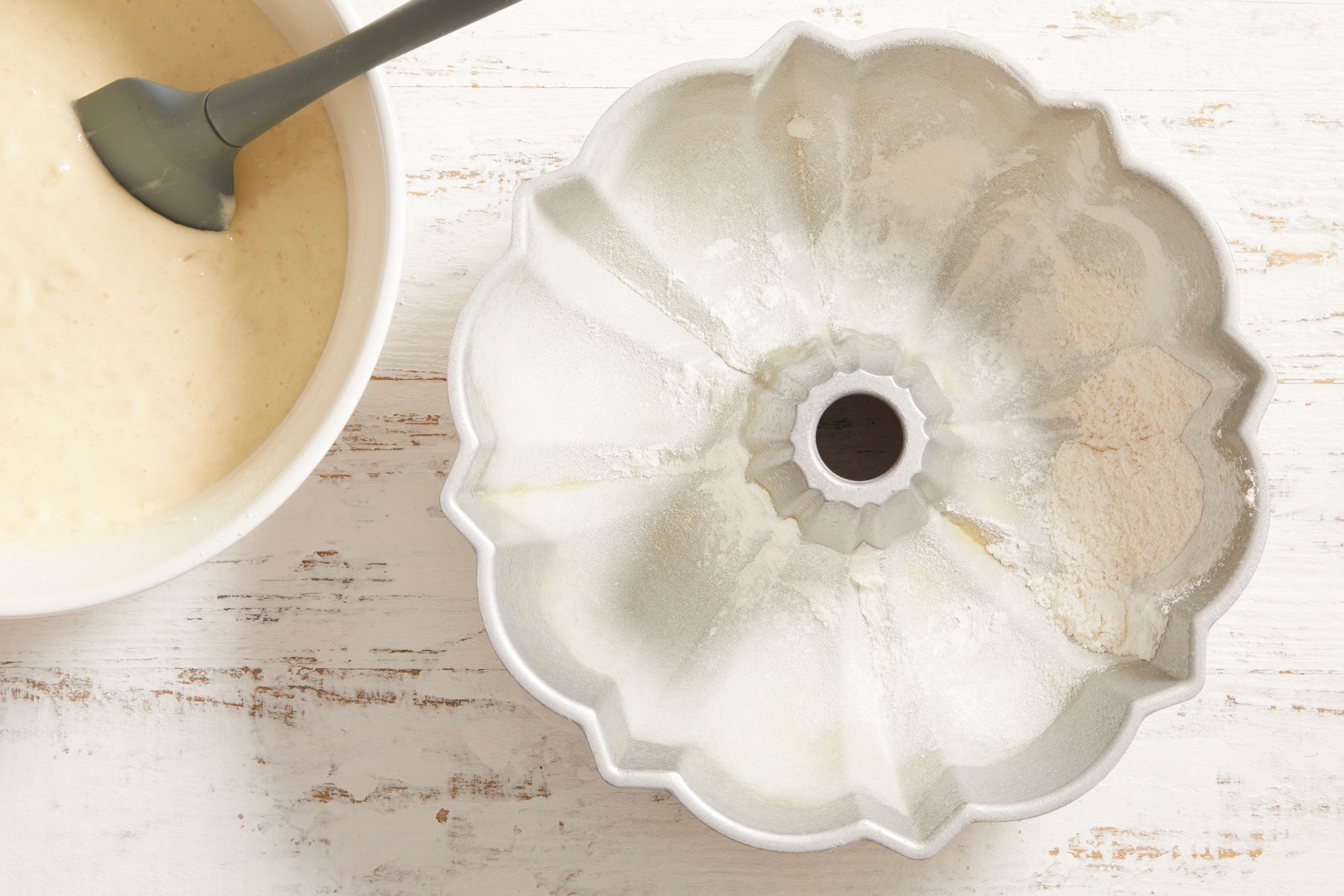 fluted tube pan with cooking spray and dust with flour.