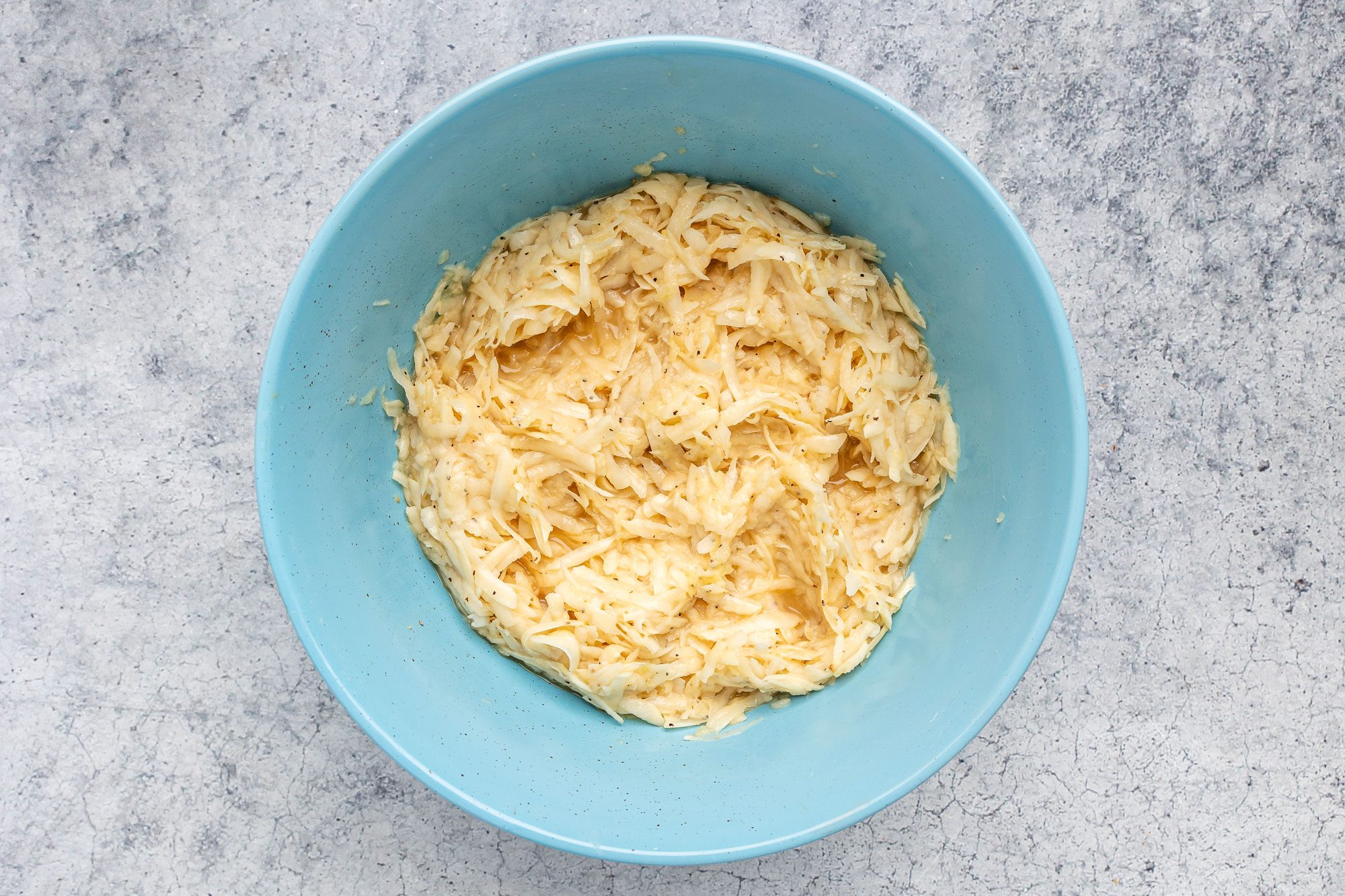 Peel and finely grate potatoes.