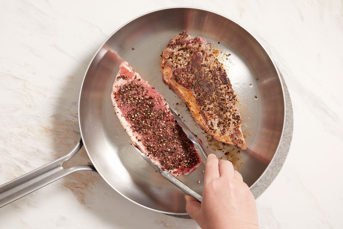 In an ungreased skillet, brown steaks on both sides over medium-high heat.