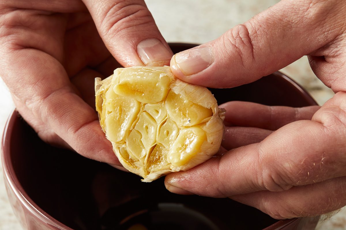 unwrapping garlic bulb