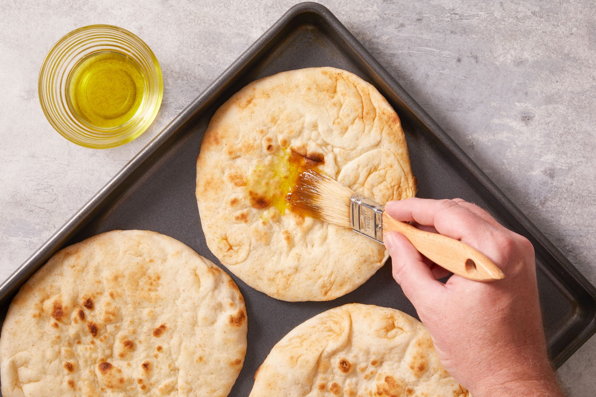Place pitas on an ungreased baking sheet; brush with oil.