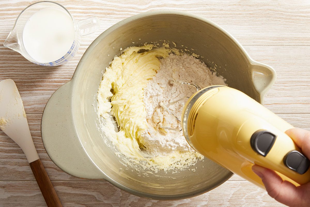 Overhead shot of the batter with flour and milk being blended smoothly with a mixer.