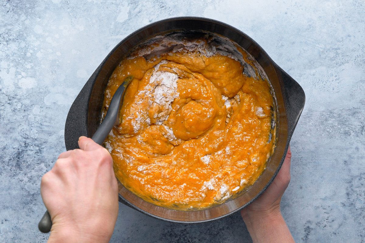 wet ingredients being mixed with dry ingredients