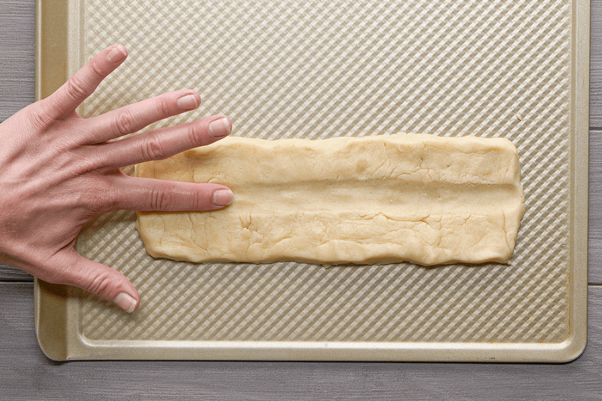 Making an indent at the centre of dough strips