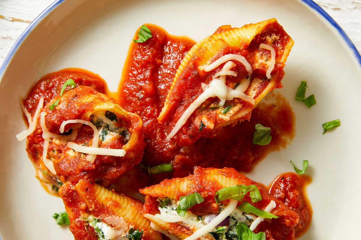 Close-up overhead shot of Slow-Cooker Stuffed Shells smothered in tomato sauce
