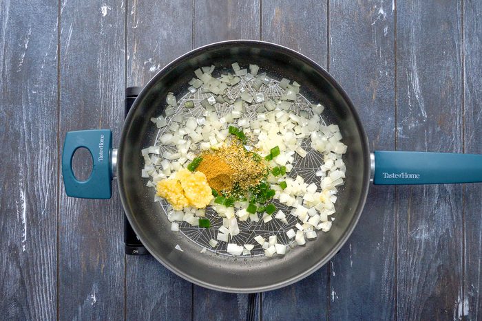 jalapeno, minced garlic, dried oregano and cumin with sautéed onion in a skillet