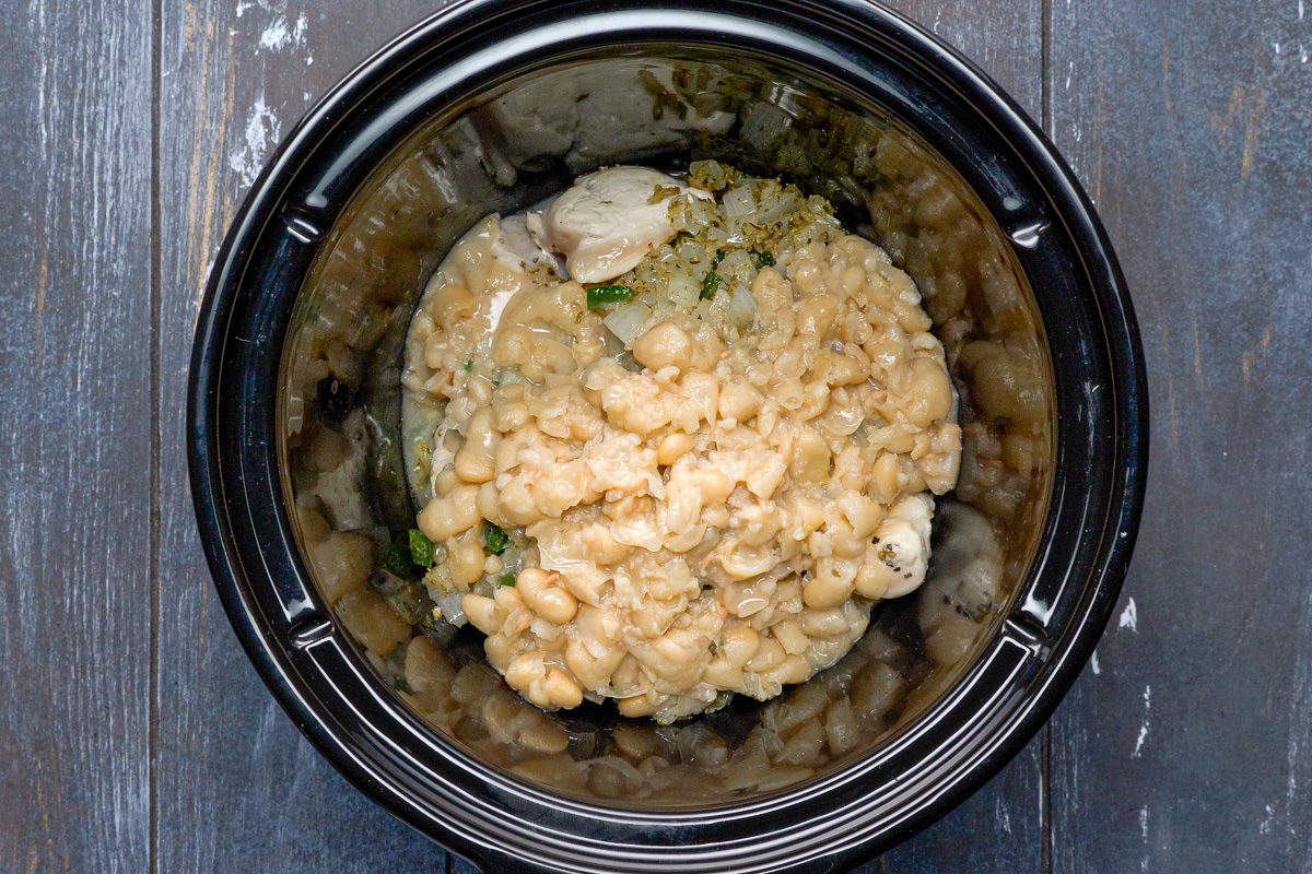 bean mixture added to chicken in slow cooker