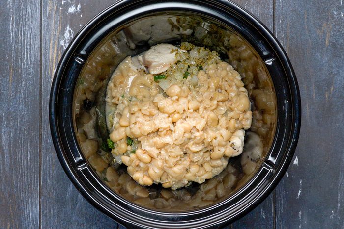 bean mixture added to chicken in slow cooker