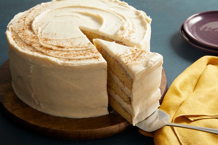 3/4 close-up of a Snickerdoodle Cake with a slice cut out, showing multiple cream-filled layers inside.