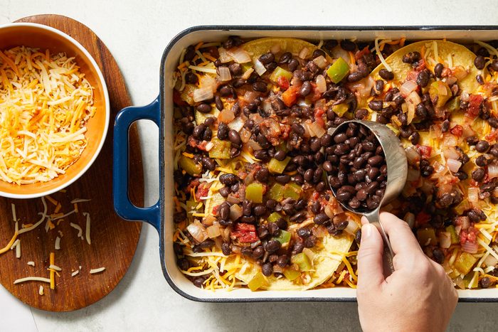 beans being added to final layer of casserole